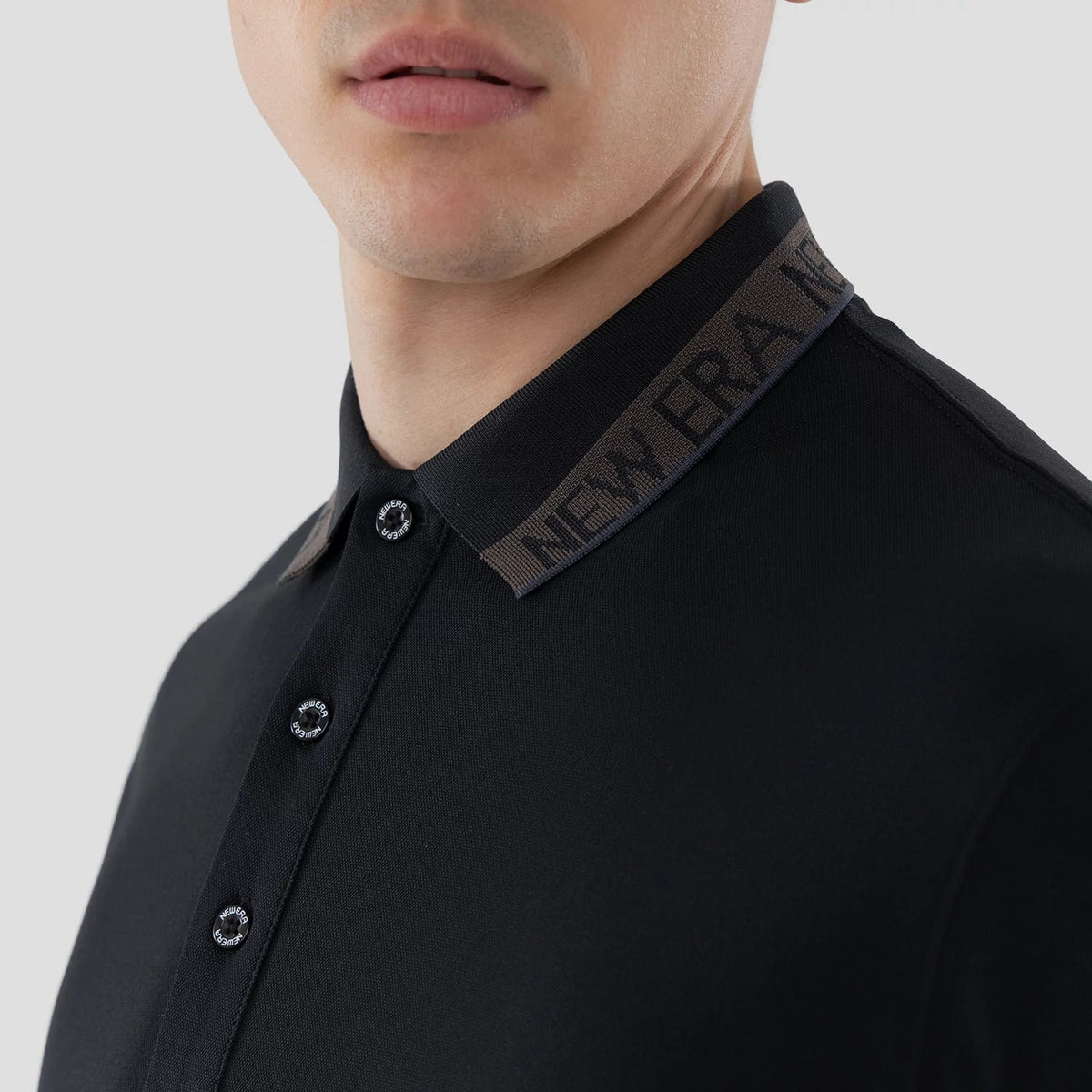 The model is wearing this New Era Kanoko Polo T-Shirt in black. 5