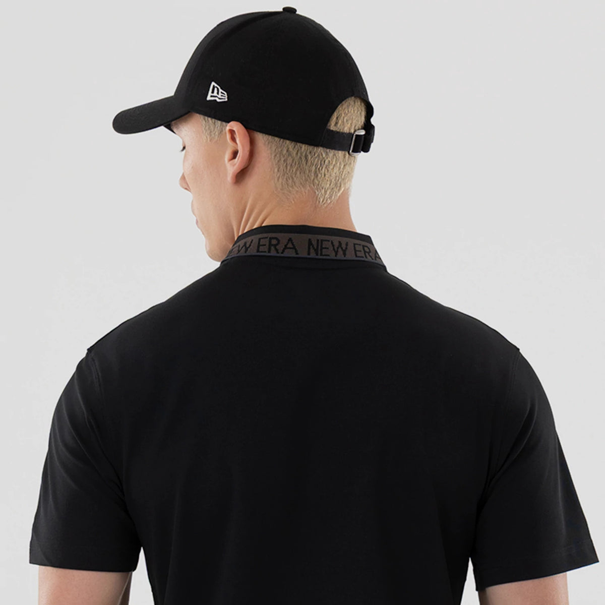The model is wearing this New Era Kanoko Polo T-Shirt in black. 6