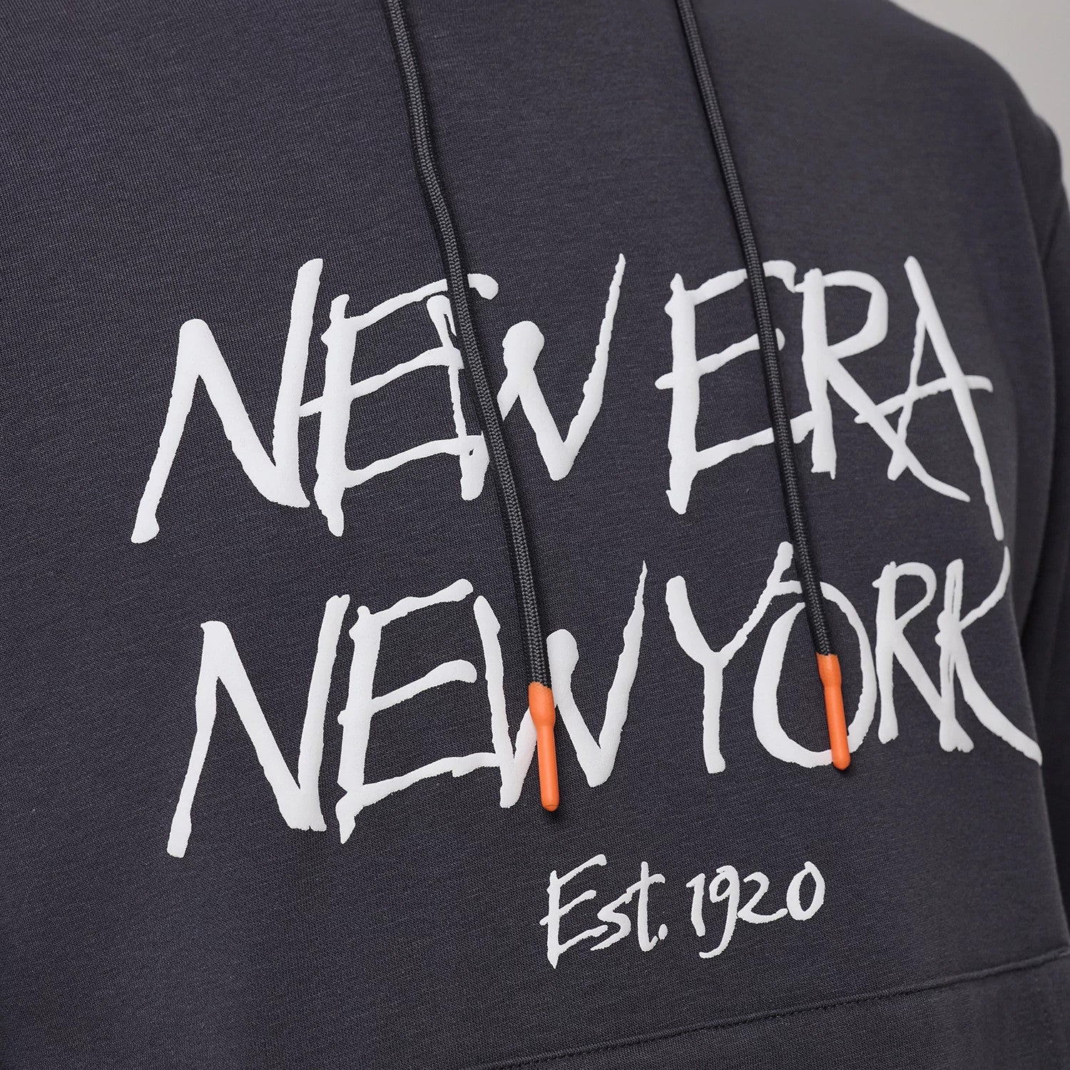 The model is wearing this New Era New York Oversized Pullover Hoodie in dark grey. 3