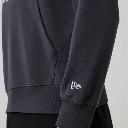 The model is wearing this New Era New York Oversized Pullover Hoodie in dark grey. 5