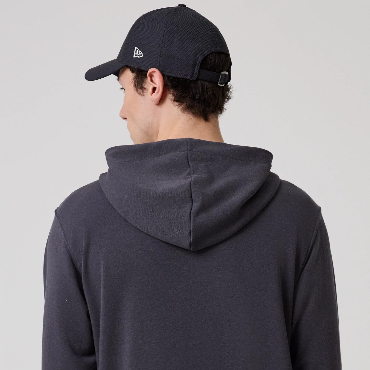 The model is wearing this New Era New York Oversized Pullover Hoodie in dark grey. 7