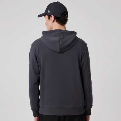 The model is wearing this New Era New York Oversized Pullover Hoodie in dark grey. 2