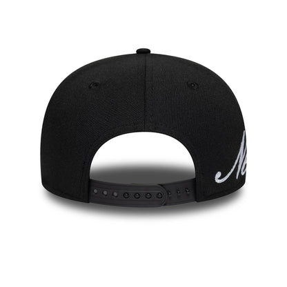 New Era Big Script Black New Era 9SEVENTY Stretch Snap Adjustable Cap, rear view showing the black snap closure and a structured crown with embroidered script detail ending near the back panels.