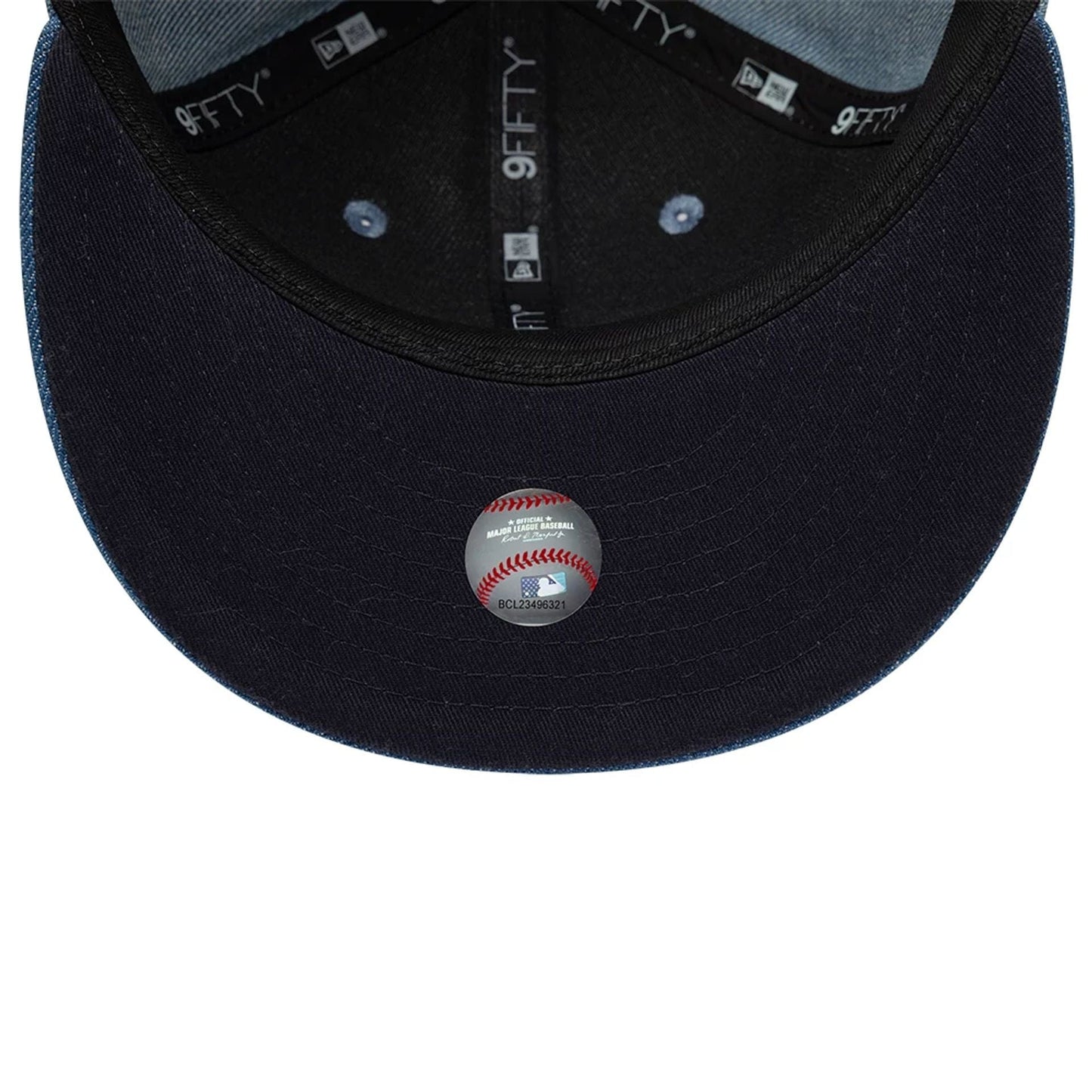 Pictured is this MLB Washed Denim New York Yankees 9FIFTY Snapback cap in navy. 2