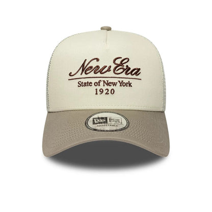 Pictured is this New Era Script 9FORTY A-Frame Trucker cap in cream. 2