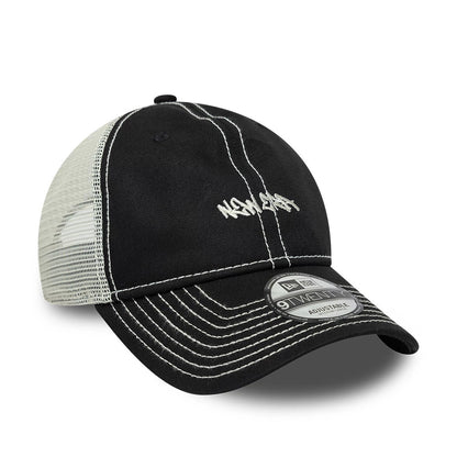 New Era Tagging Logo Black New Era 9TWENTY Trucker Adjustable Cap, three-quarter view showing white stitched graffiti-style logo on the front panel, white mesh back, black visor with contrasting white stitching, and 9TWENTY size sticker.
