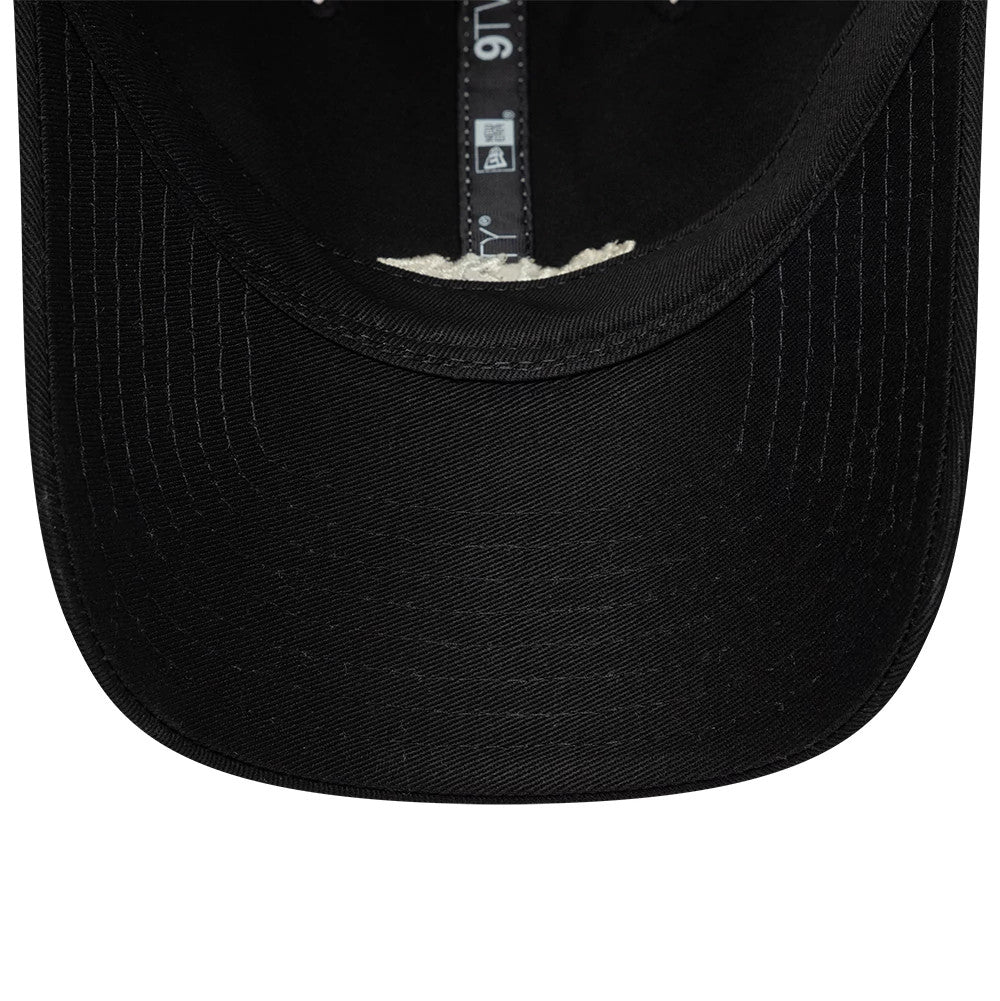 New Era Tagging Logo Black New Era 9TWENTY Trucker Adjustable Cap, inside view showing black sweatband and taping with the 9TWENTY label, alongside the clean black undervisor stitching detail.