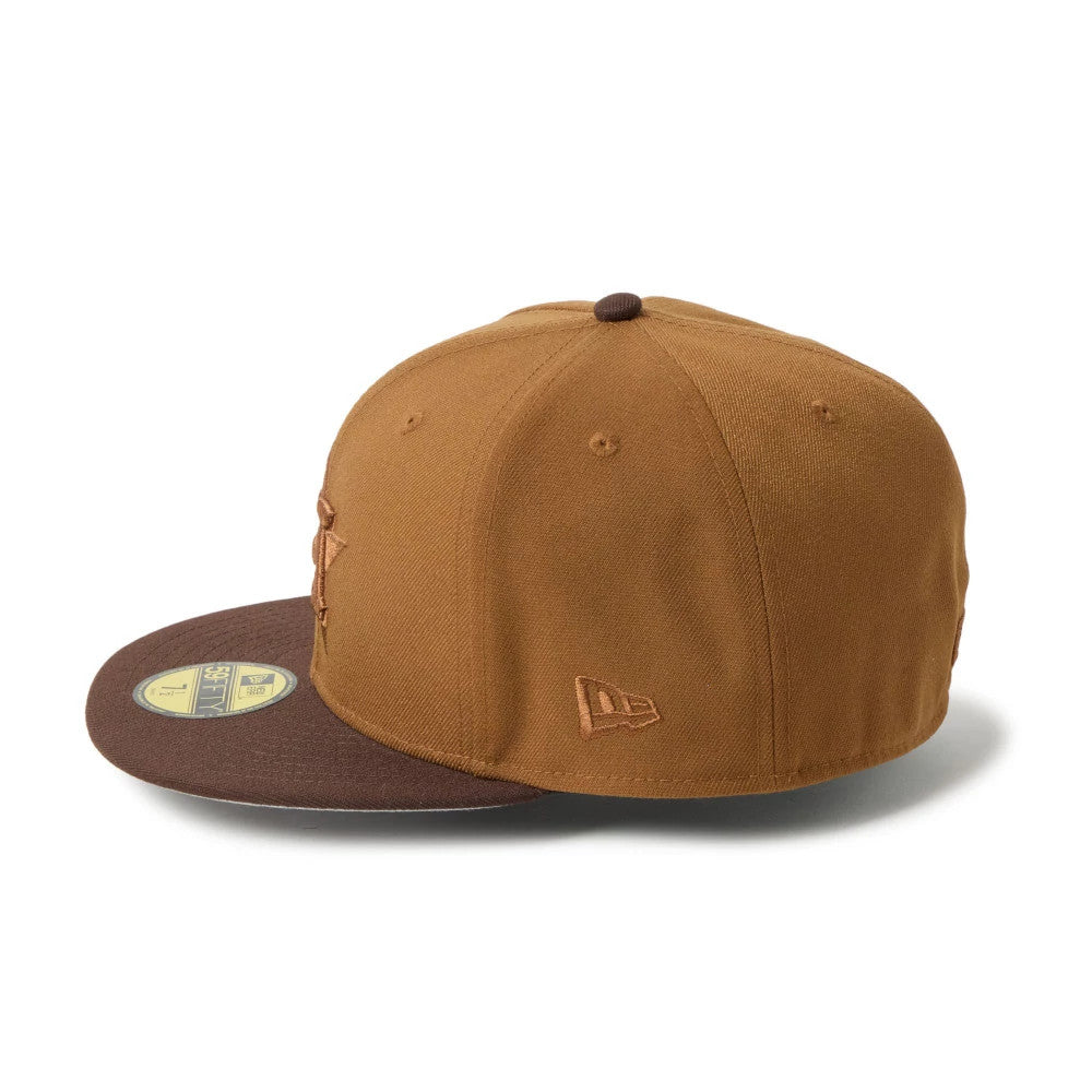 Houston Astros MLB Brown New Era 59FIFTY Fitted Cap, side view showing the brown New Era flag logo embroidered on the left side of the structured brown crown and a gold 59FIFTY size sticker on the brown visor.
