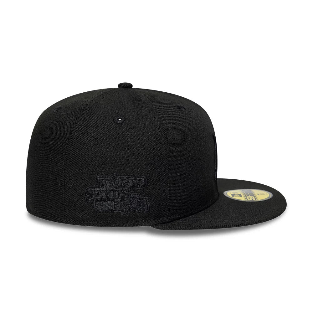 Detroit Tigers MLB Black On Black New Era 59FIFTY Fitted Cap, side view showing raised black World Series 1984 embroidery on the structured crown, with a 59FIFTY size sticker on the flat black visor.