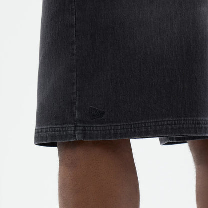 The model is wearing this New Era Washed Bermuda Shorts in black. 5
