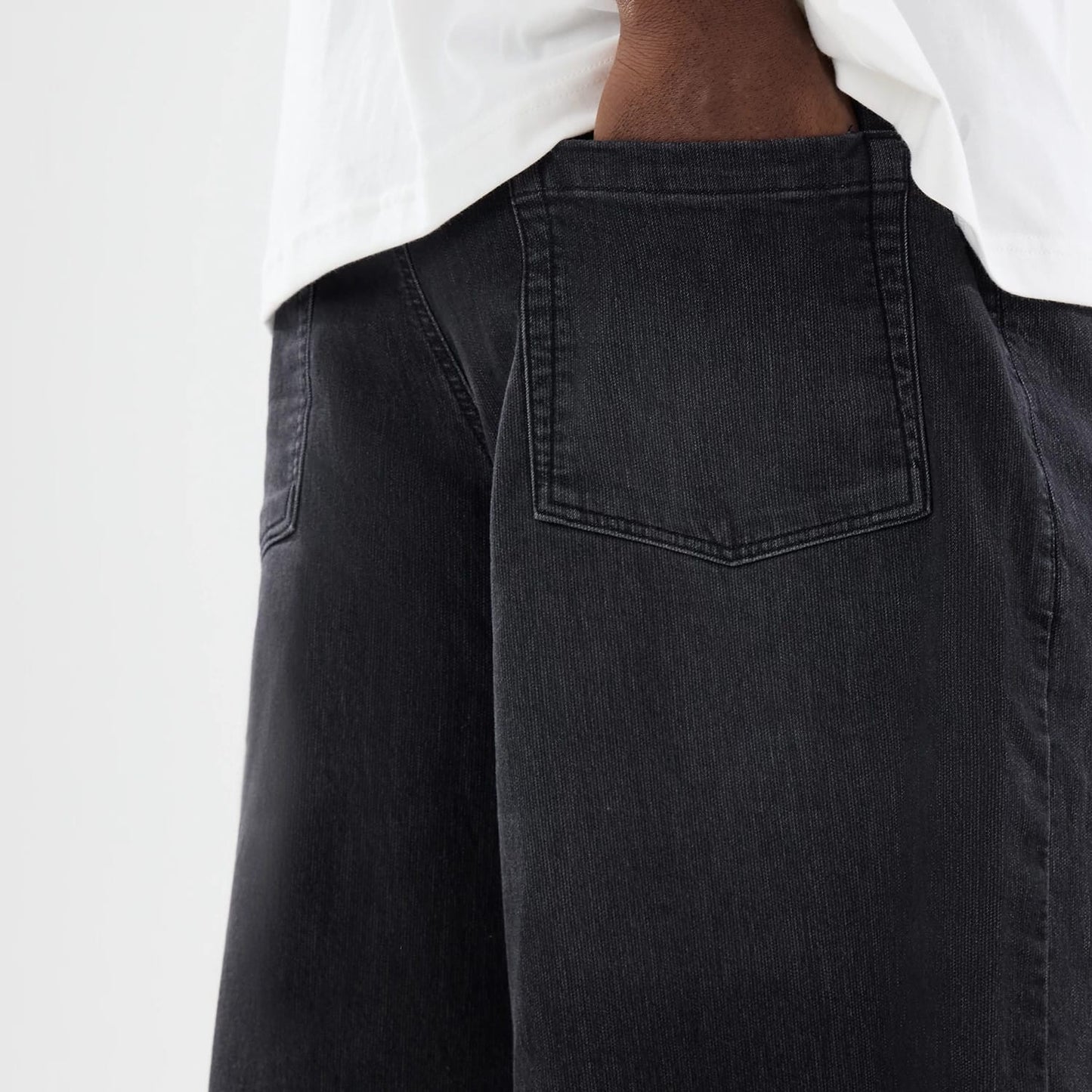 The model is wearing this New Era Washed Bermuda Shorts in black. 7