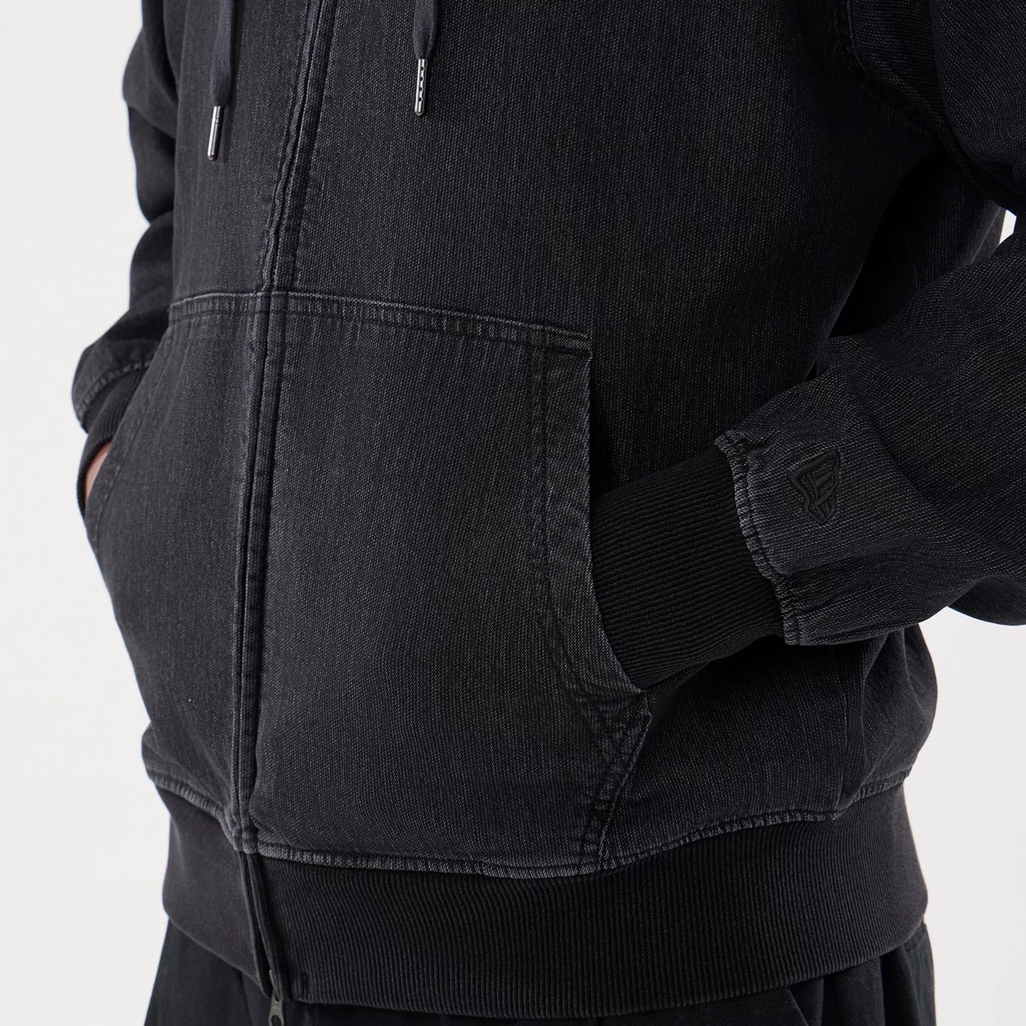 The model is wearing this New Era Washed Full Zip Hoodie in black. 5