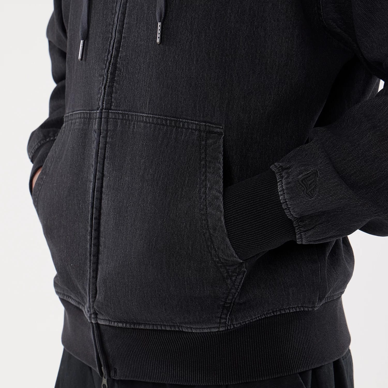 The model is wearing this New Era Washed Full Zip Hoodie in black. 5