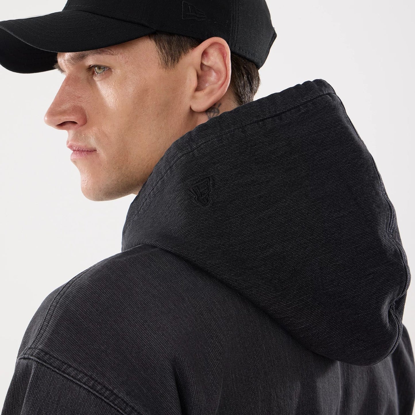 The model is wearing this New Era Washed Full Zip Hoodie in black. 7