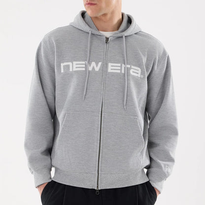 The model is wearing this New Era Waffle Full Zip Hoodie in grey. 3