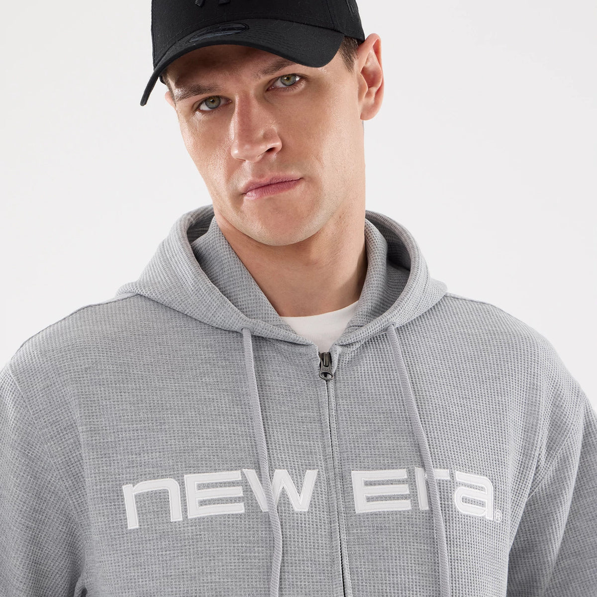 The model is wearing this New Era Waffle Full Zip Hoodie in grey. 4