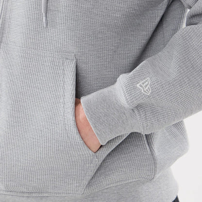 The model is wearing this New Era Waffle Full Zip Hoodie in grey. 5