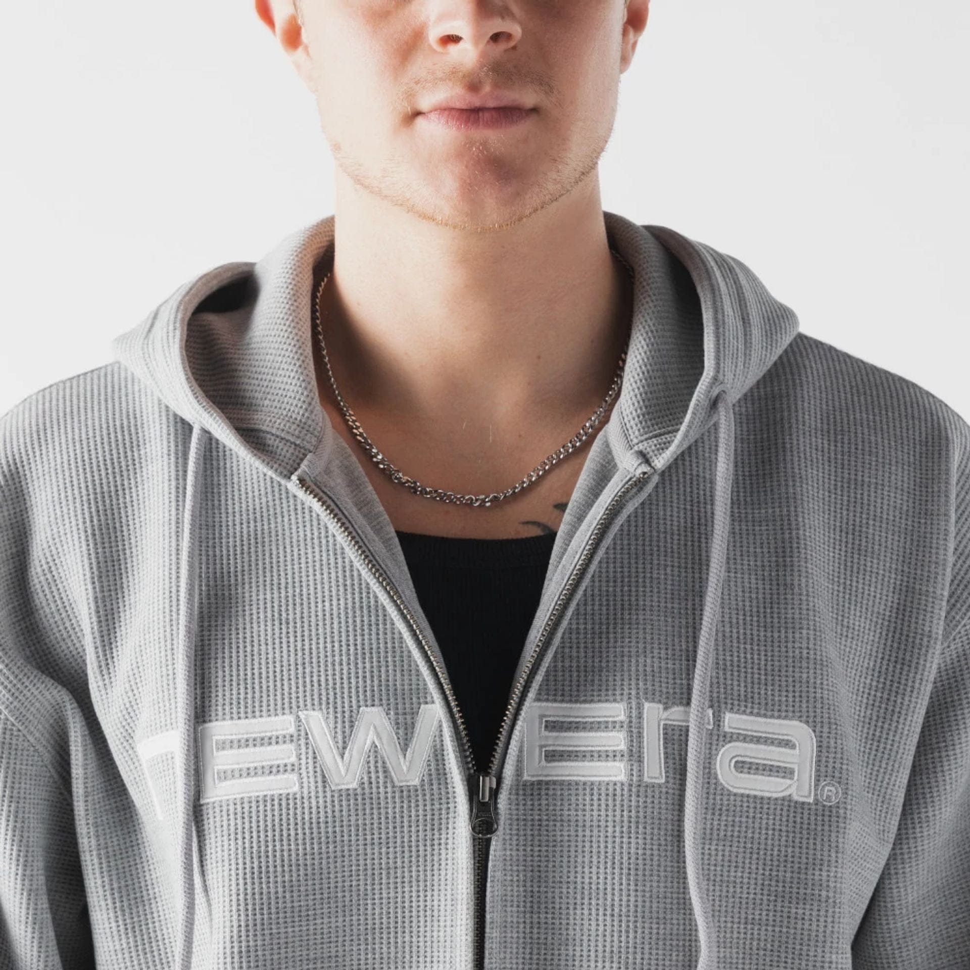 The model is wearing this New Era Waffle Full Zip Hoodie in grey. 3