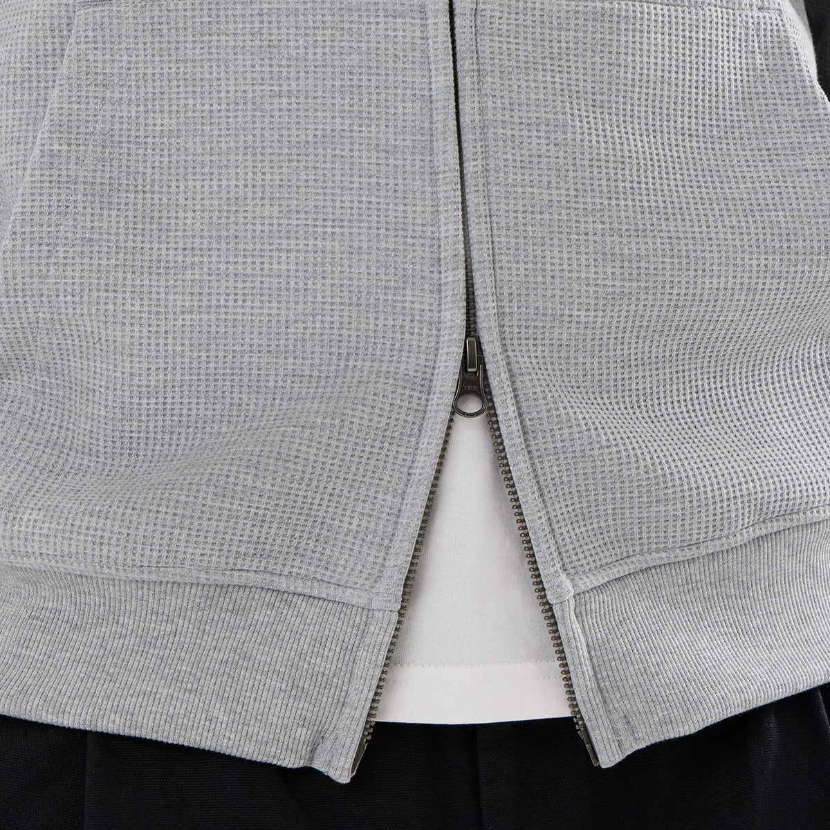The model is wearing this New Era Waffle Full Zip Hoodie in grey. 6