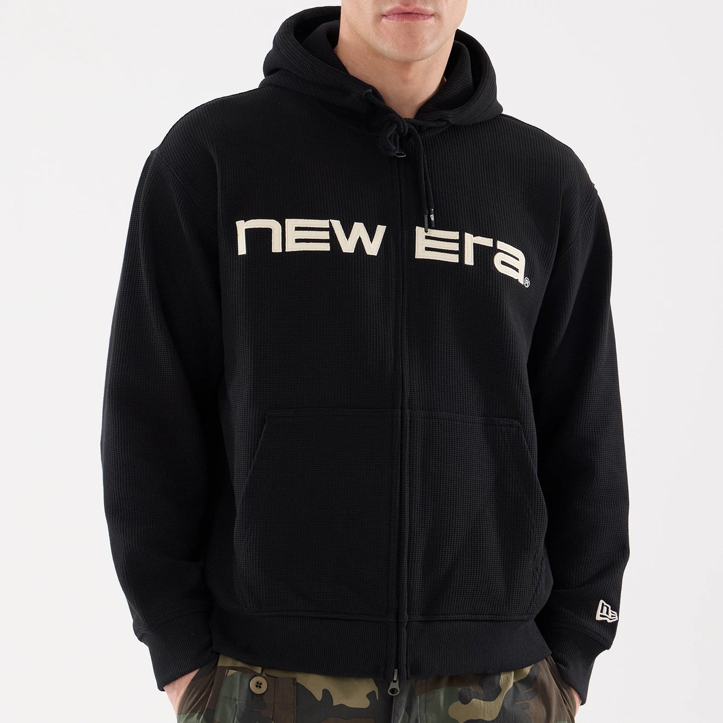 The model is wearing this New Era Waffle Full Zip Hoodie in black. 4