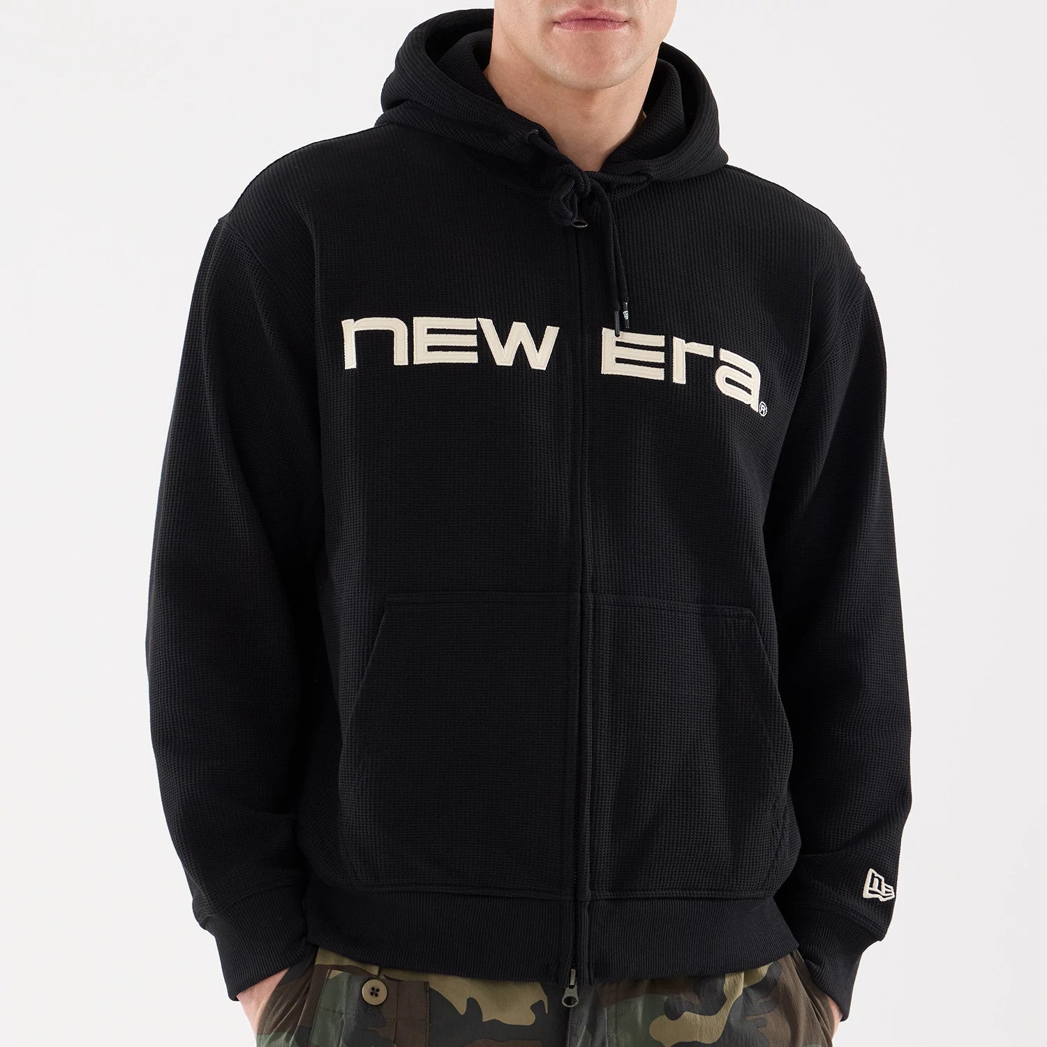 The model is wearing this New Era Waffle Full Zip Hoodie in black. 4