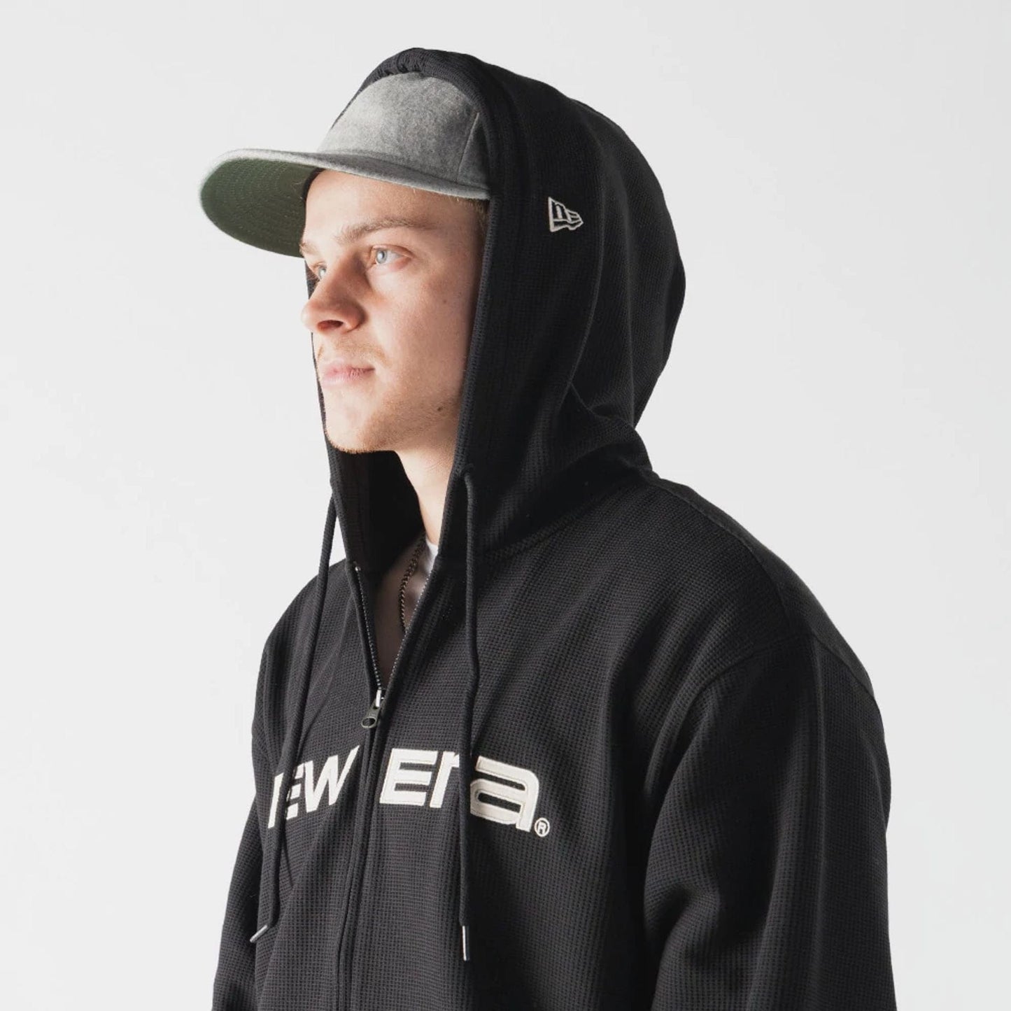 The model is wearing this New Era Waffle Full Zip Hoodie in black. 5