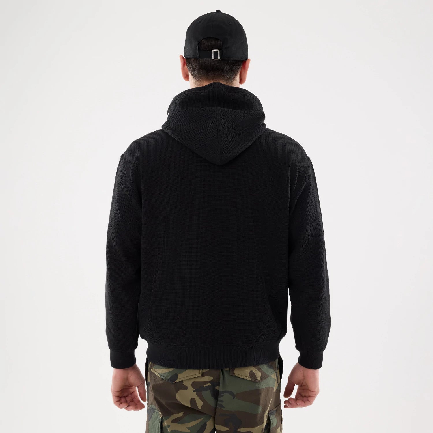 The model is wearing this New Era Waffle Full Zip Hoodie in black. 2