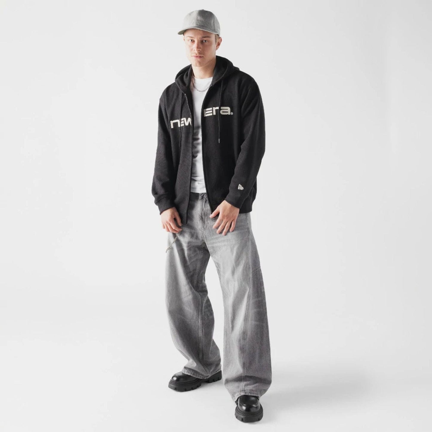 The model is wearing this New Era Waffle Full Zip Hoodie in black. 6