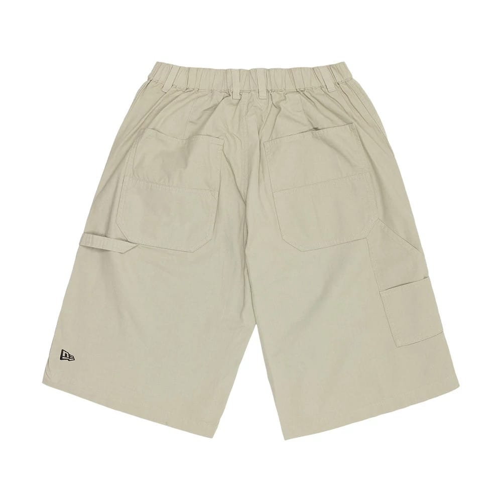The model is wearing this New Era Canvas Bermuda Shorts in beige. 6