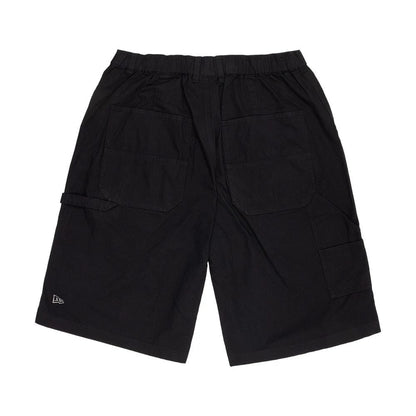 The model is wearing this New Era Canvas Bermuda Shorts in black. 6