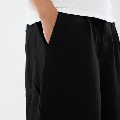 The model is wearing this New Era Canvas Bermuda Shorts in black. 7