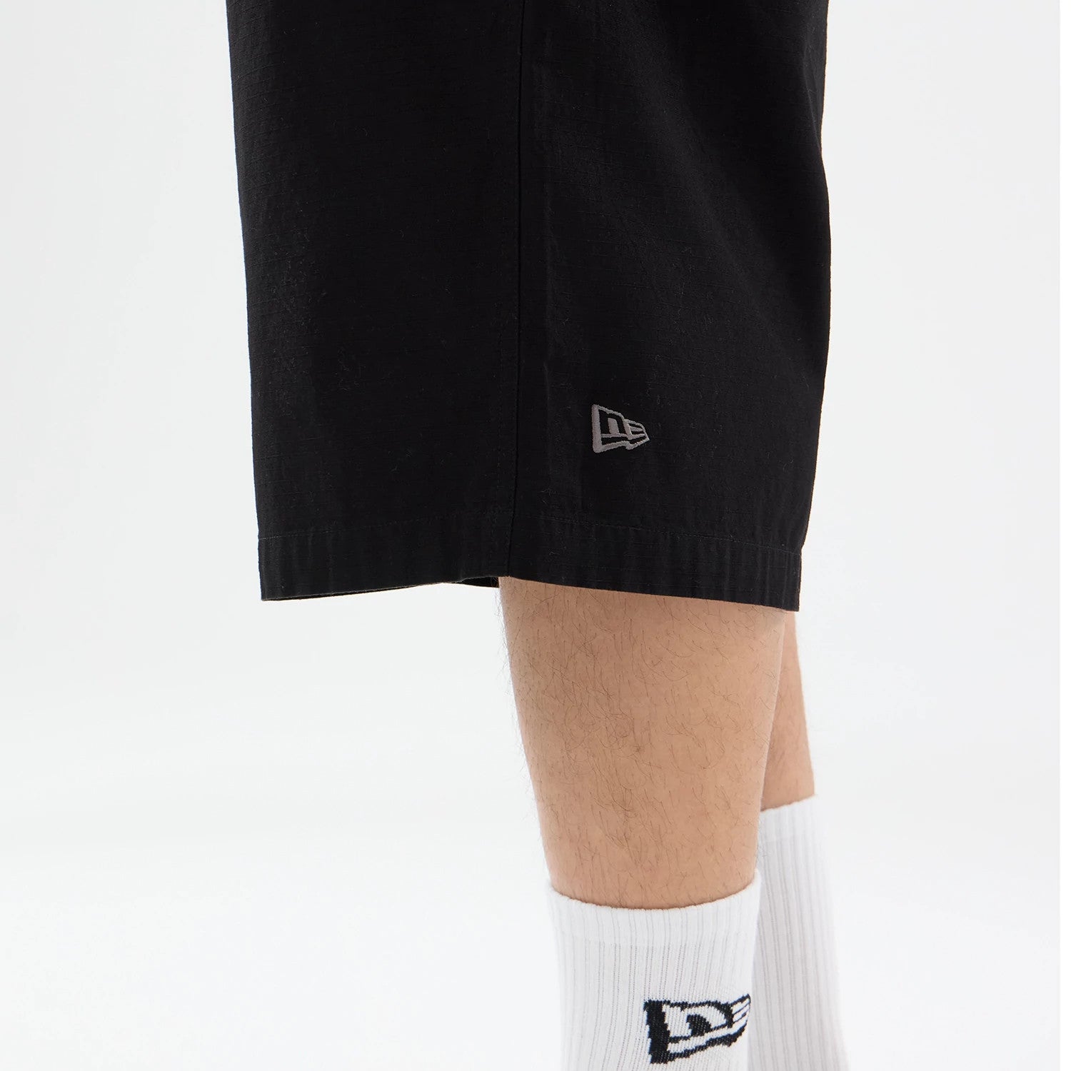 The model is wearing this New Era Canvas Bermuda Shorts in black. 3