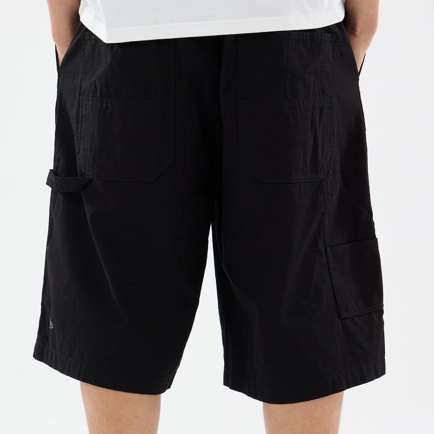 The model is wearing this New Era Canvas Bermuda Shorts in black. 5