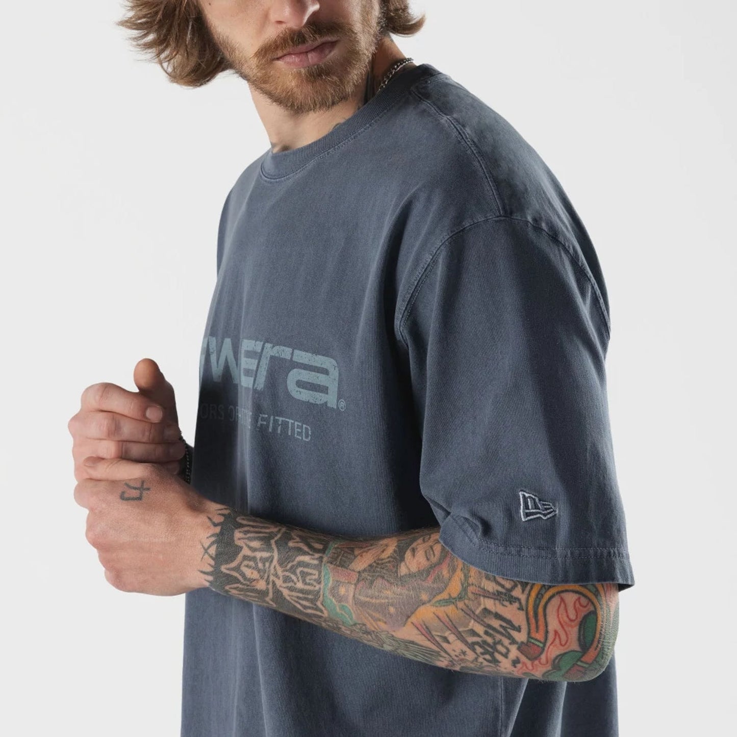 The model is wearing this New Era Originators T-Shirt in navy. 4