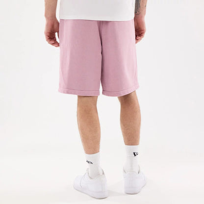The model is wearing this New Era Originators Oversized Shorts in pink. 2