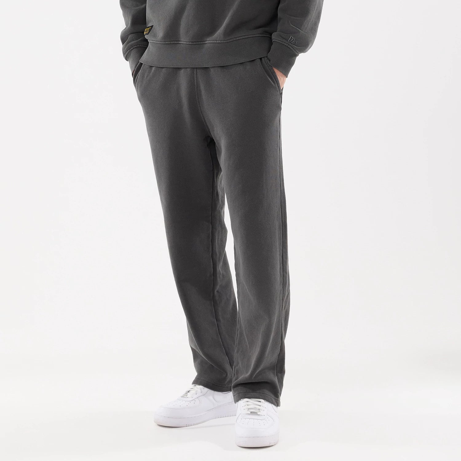 The model is wearing this New Era Originators Straight Leg Joggers in black. 1