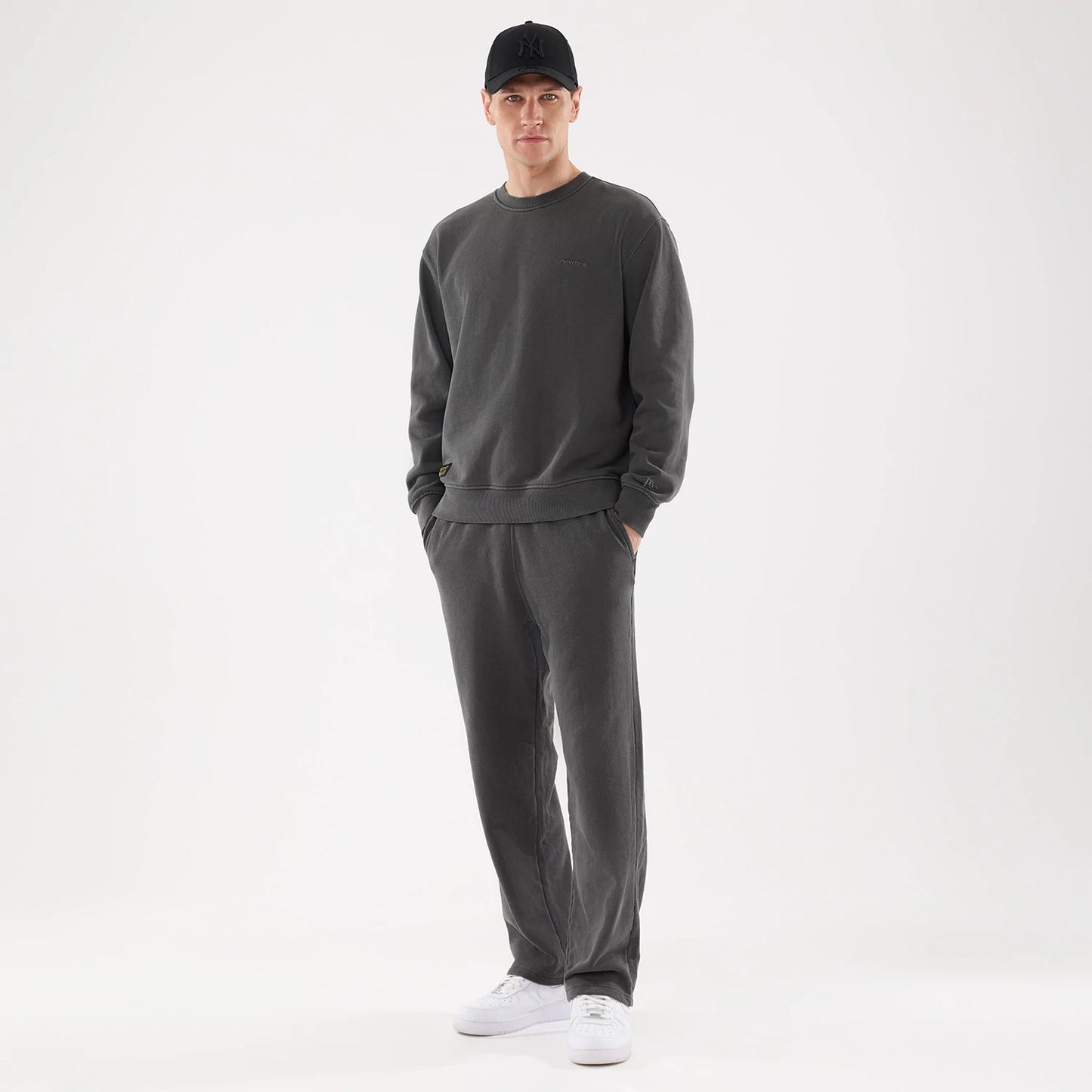The model is wearing this New Era Originators Straight Leg Joggers in black. 8