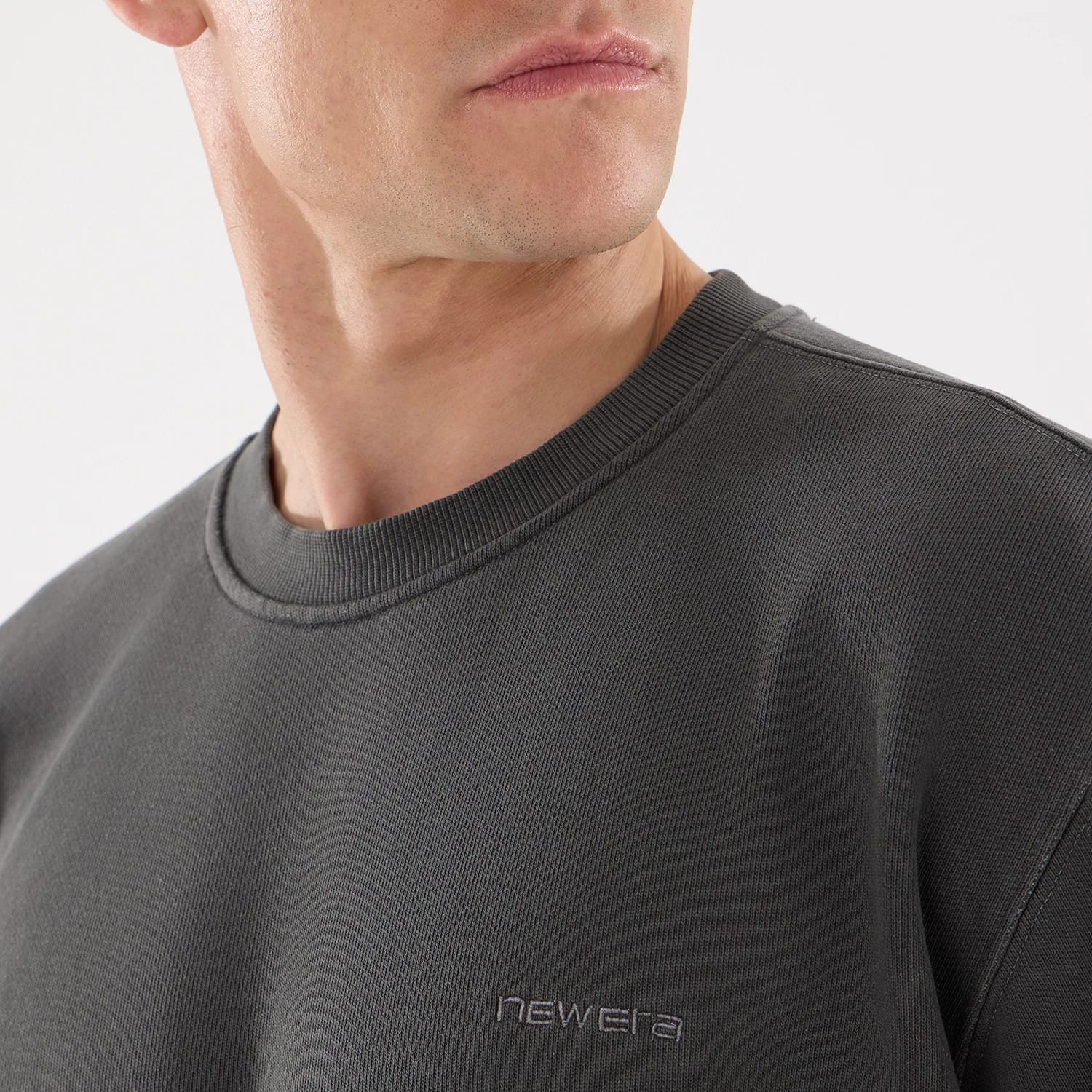 The model is wearing this New Era Originators Crew Neck Sweater in black. 3