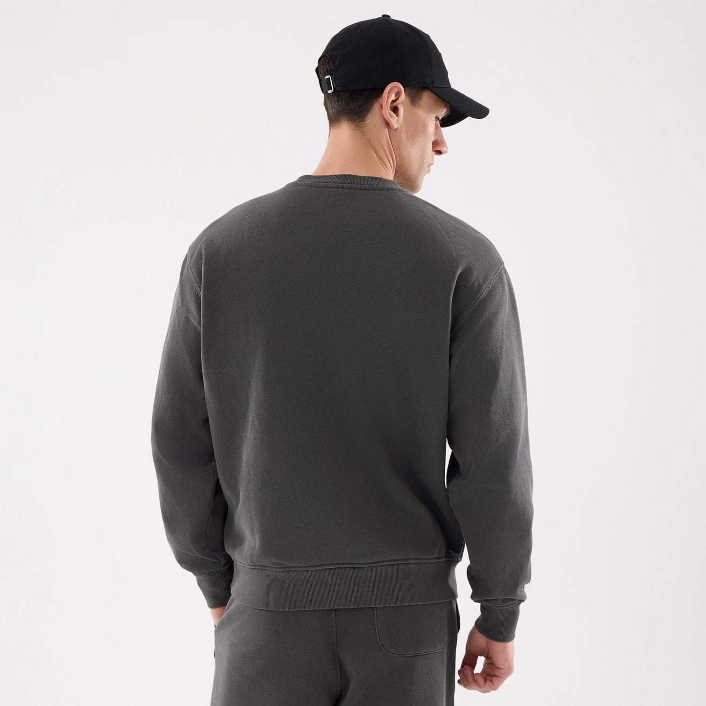The model is wearing this New Era Originators Crew Neck Sweater in black. 7