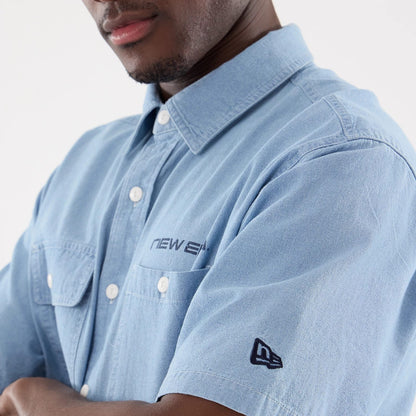 The model is wearing this New Era Originators Chambray Short Sleeve Shirt in bright blue. 5