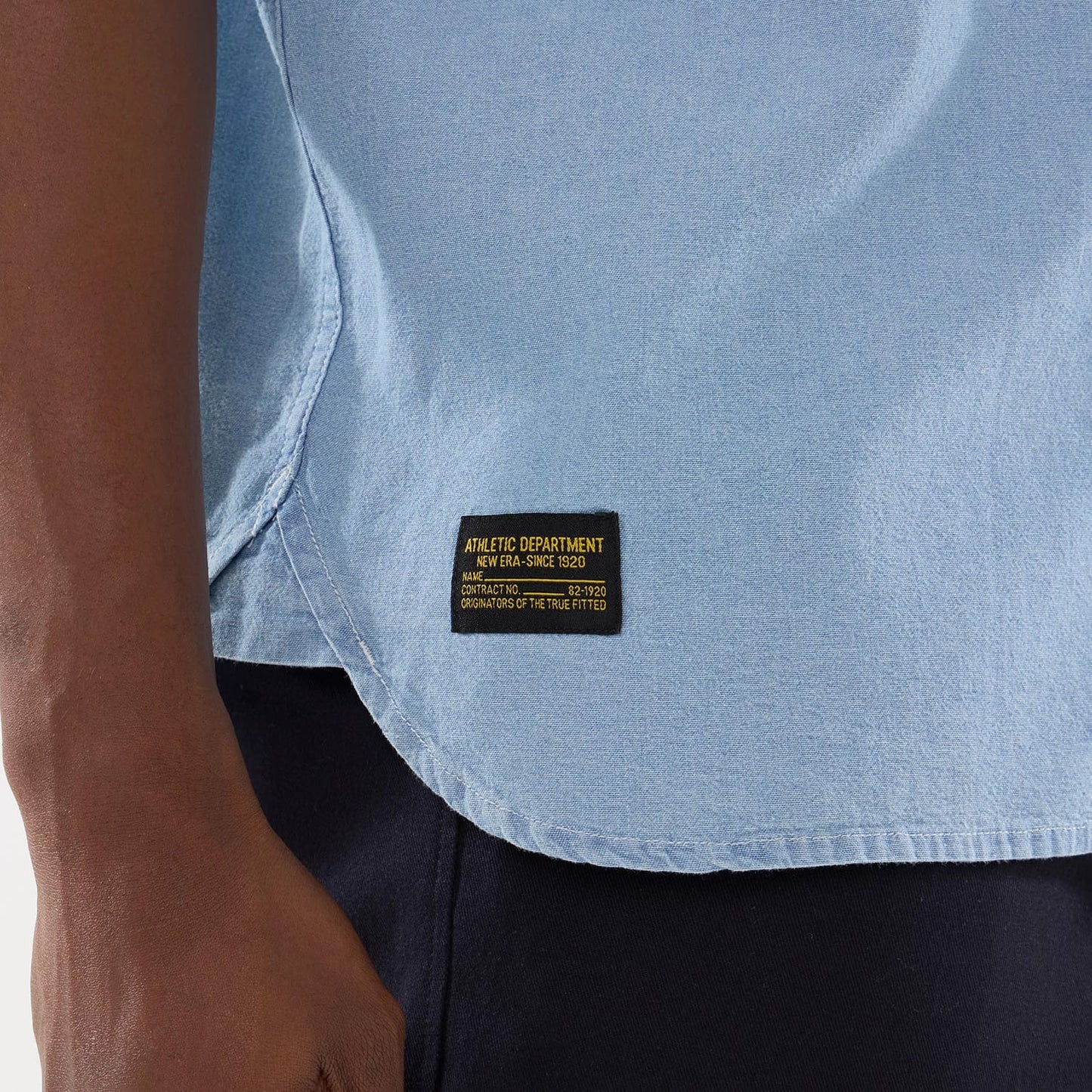 The model is wearing this New Era Originators Chambray Short Sleeve Shirt in bright blue. 6