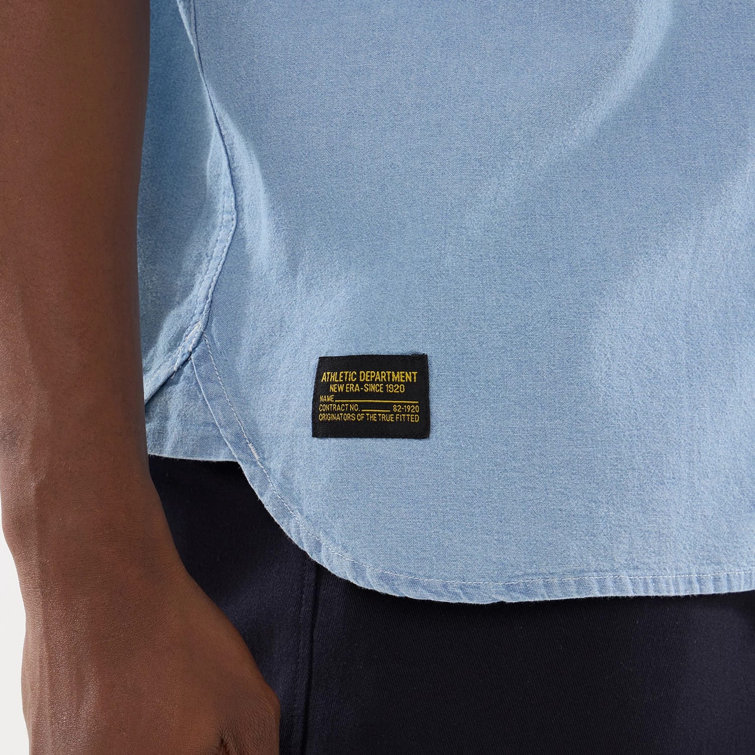 The model is wearing this New Era Originators Chambray Short Sleeve Shirt in bright blue. 6
