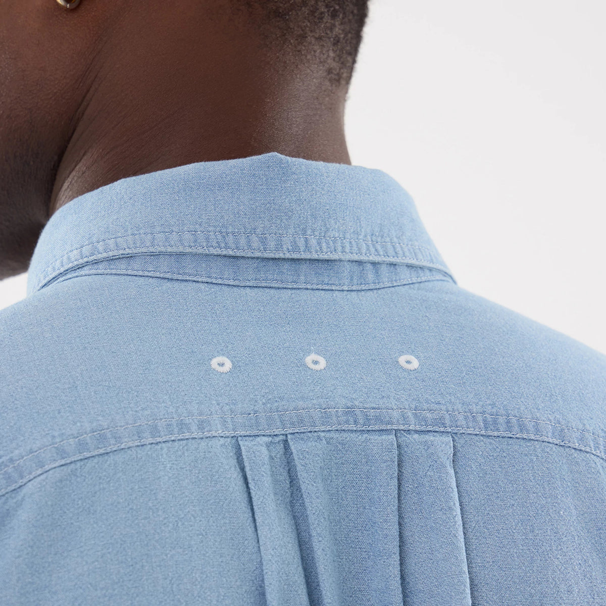 The model is wearing this New Era Originators Chambray Short Sleeve Shirt in bright blue. 7