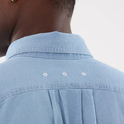 The model is wearing this New Era Originators Chambray Short Sleeve Shirt in bright blue. 7