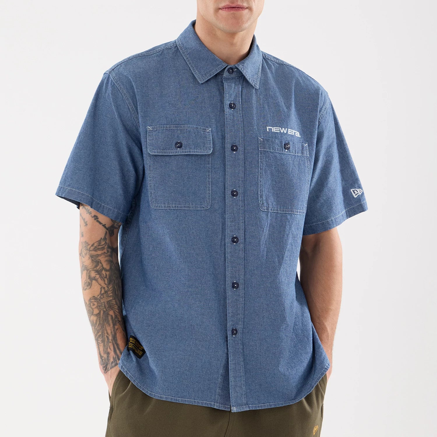 The model is wearing this New Era Originators Chambray Short Sleeve Shirt in dark blue. 3
