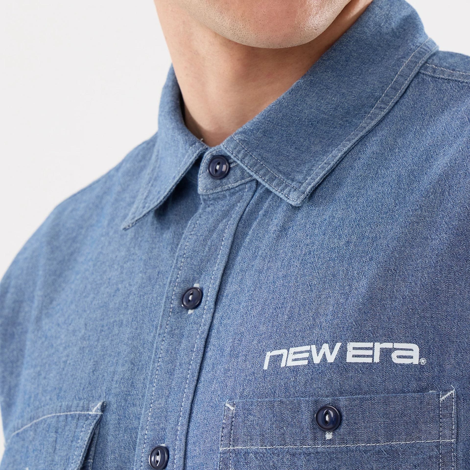 The model is wearing this New Era Originators Chambray Short Sleeve Shirt in dark blue. 4
