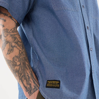 The model is wearing this New Era Originators Chambray Short Sleeve Shirt in dark blue. 6
