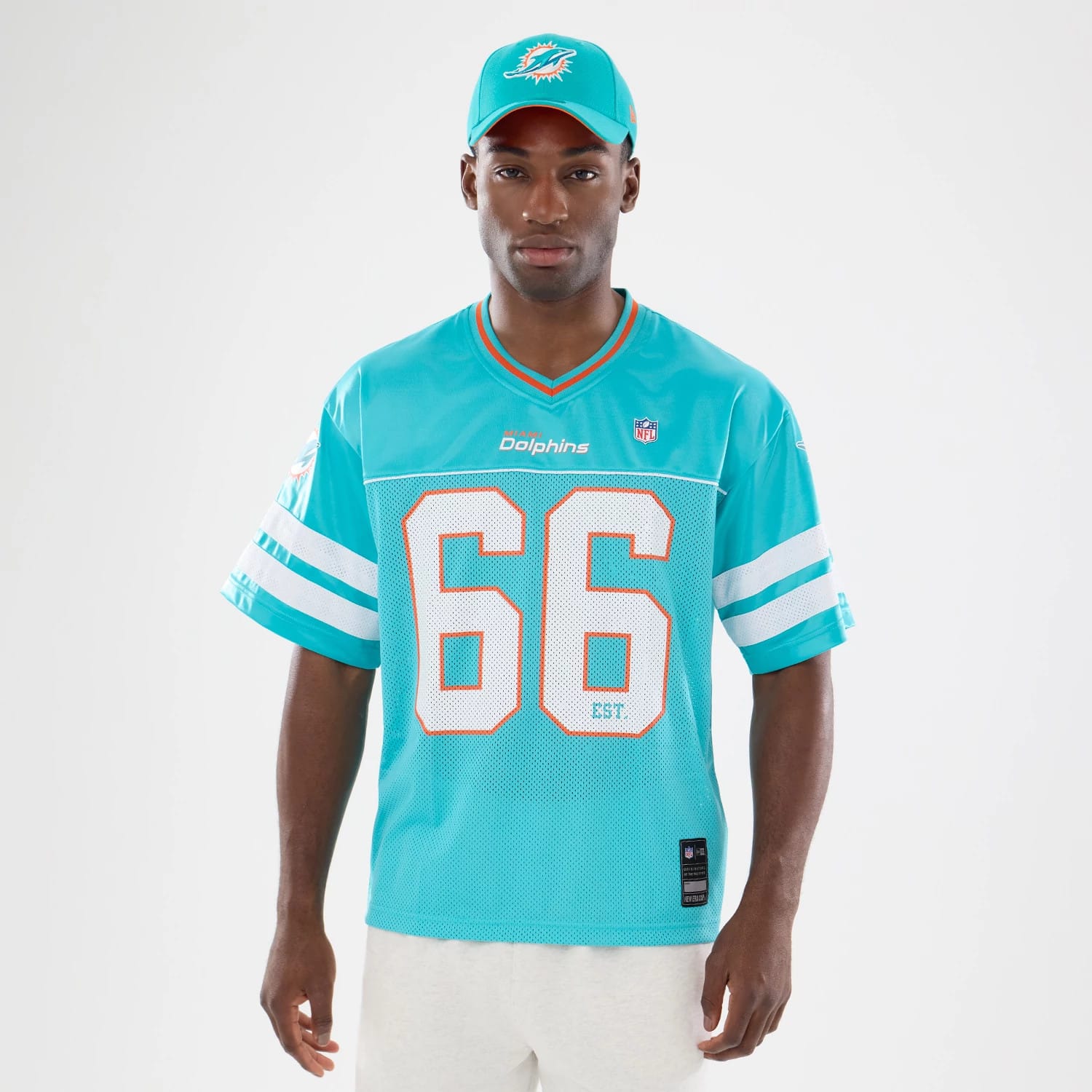 The model is wearing this NFL Miami Dolphins Mesh Jersey in turquoise. 7