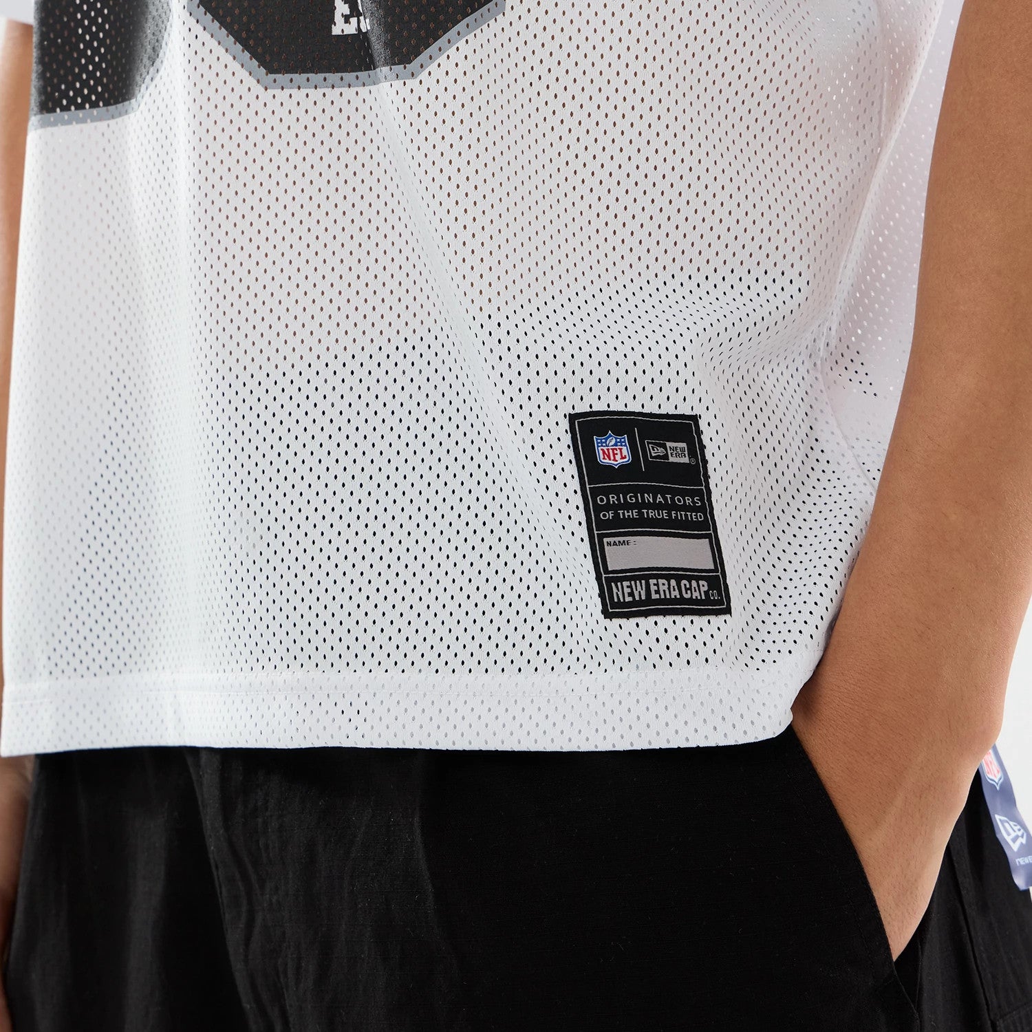 The model is wearing this NFL Las Vegas Raiders Mesh Jersey in white. 4