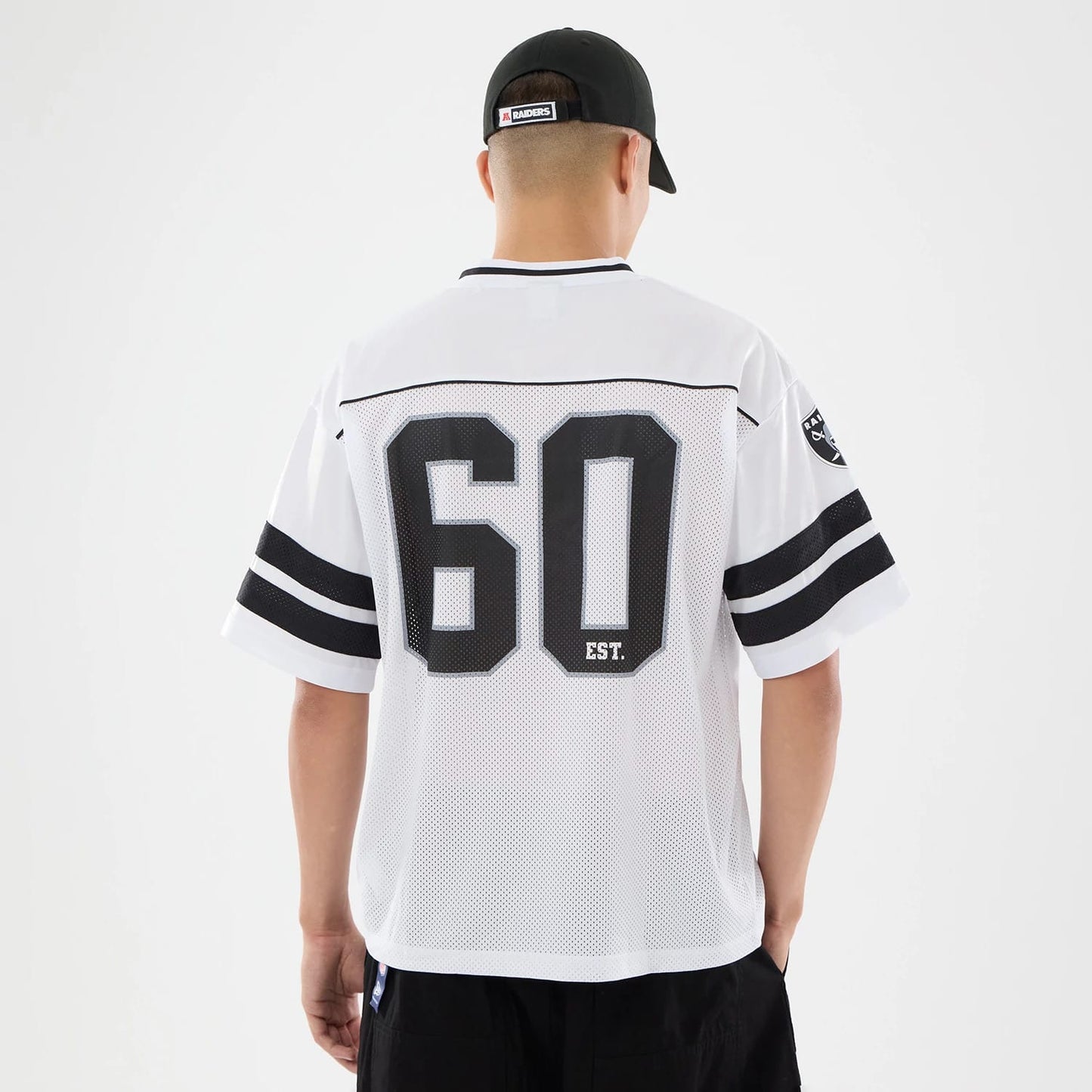 The model is wearing this NFL Las Vegas Raiders Mesh Jersey in white. 2